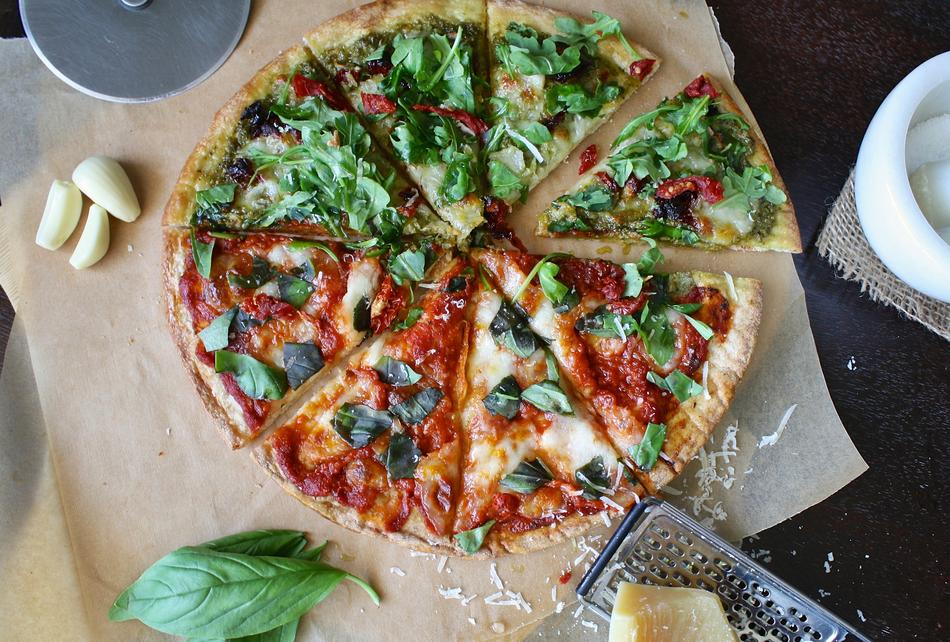 pizza with basil on parchment paper