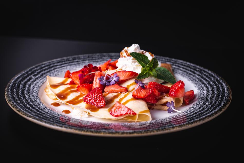 Beautiful crapes with colorful fruits and cream