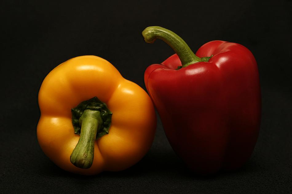 yellow and red peppers on a black background