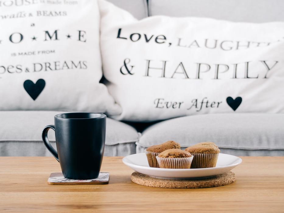 Breakfast on table in front of sofa, Muffins and Coffee