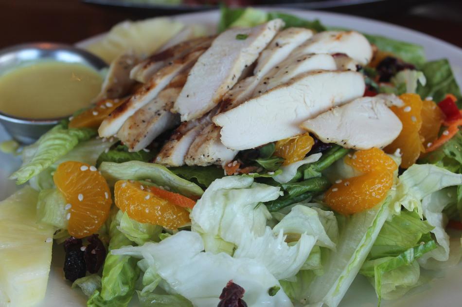 salad with chicken, vegetables and tangerines