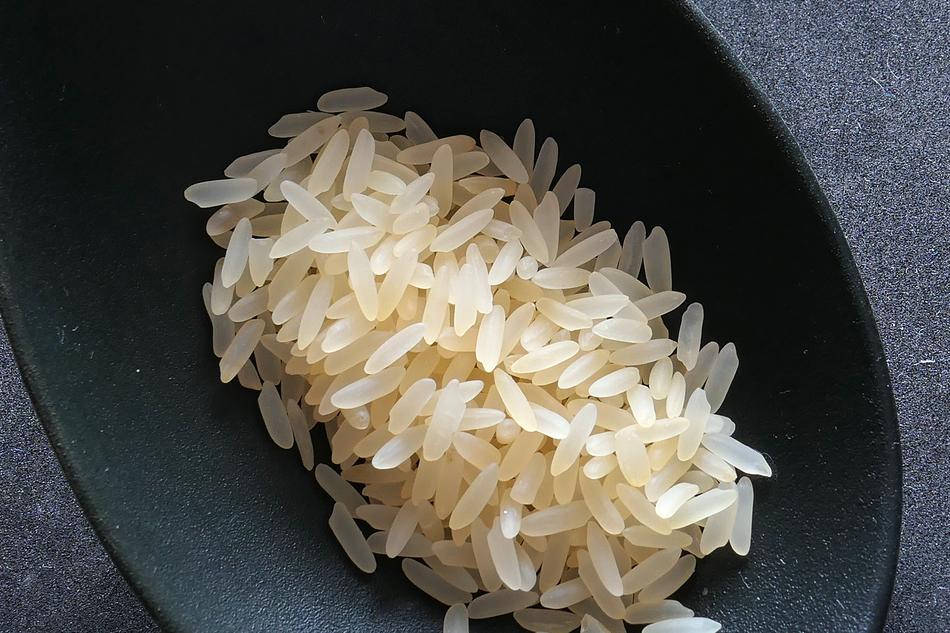 white rice in a black spoon