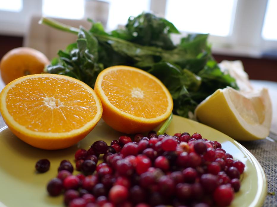 Oranges and cranberry on plate