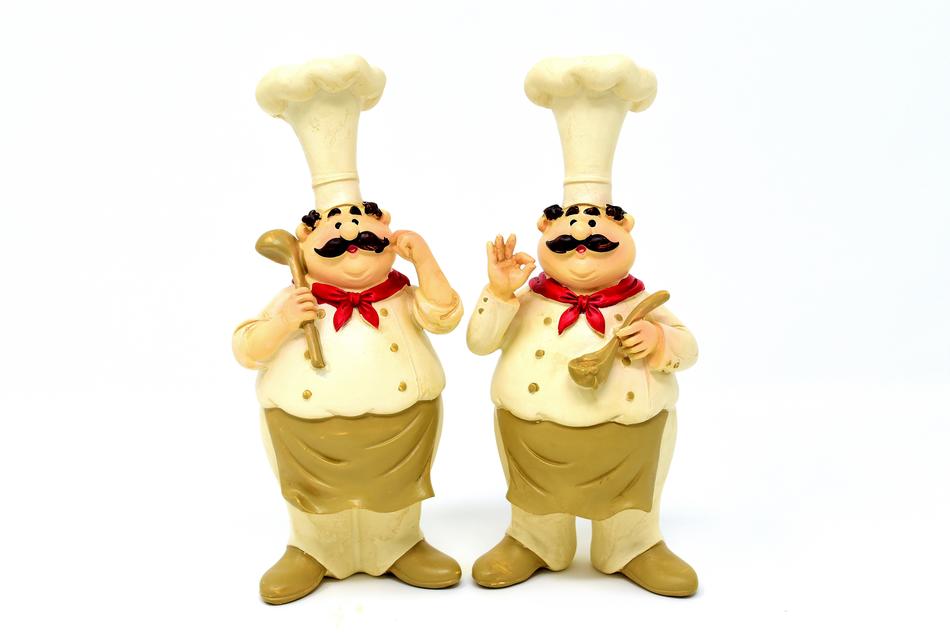 two statues of a chef