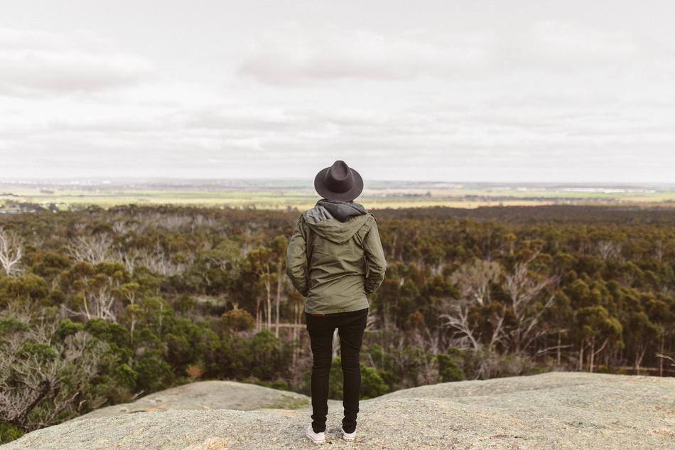 photo of a girl in a hat on a high hill