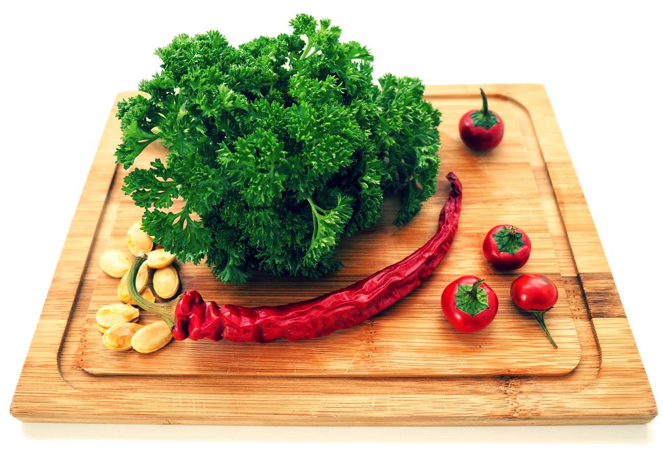 vegetables and green parsley on the kitchen board