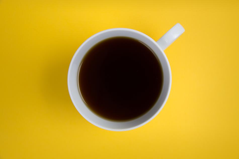 Cup of coffee at yellow background