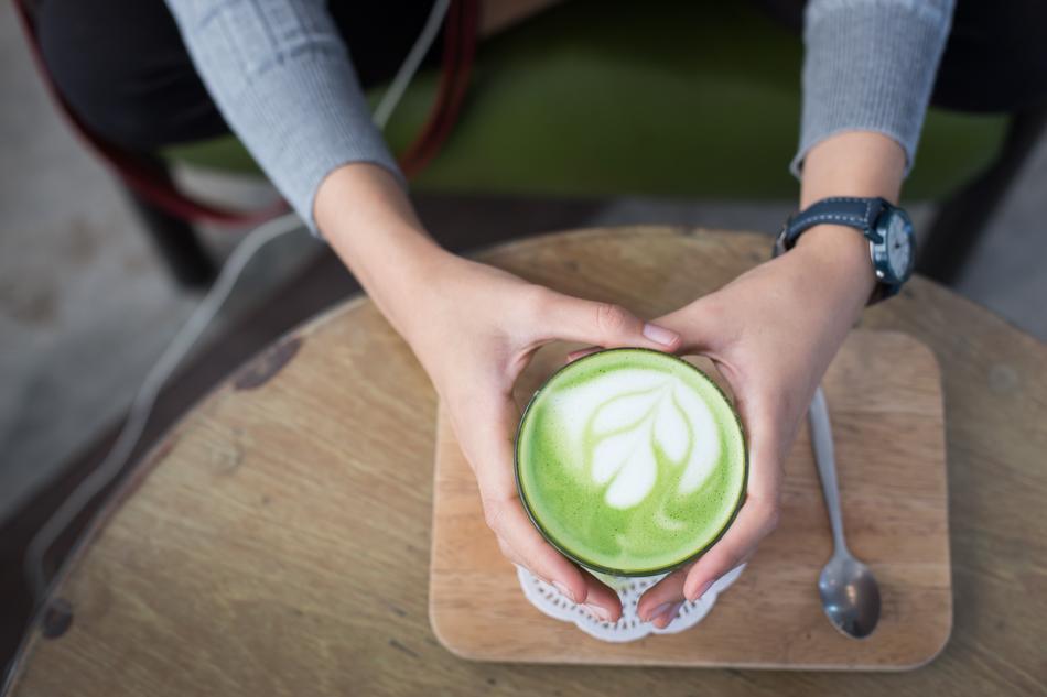 hot matcha latte in hands