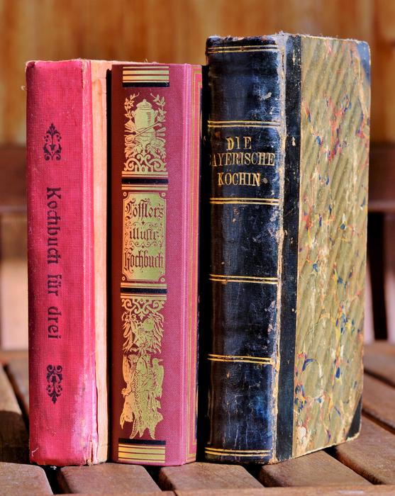 Colorful and beautiful, antique cookbooks, on the wooden surface