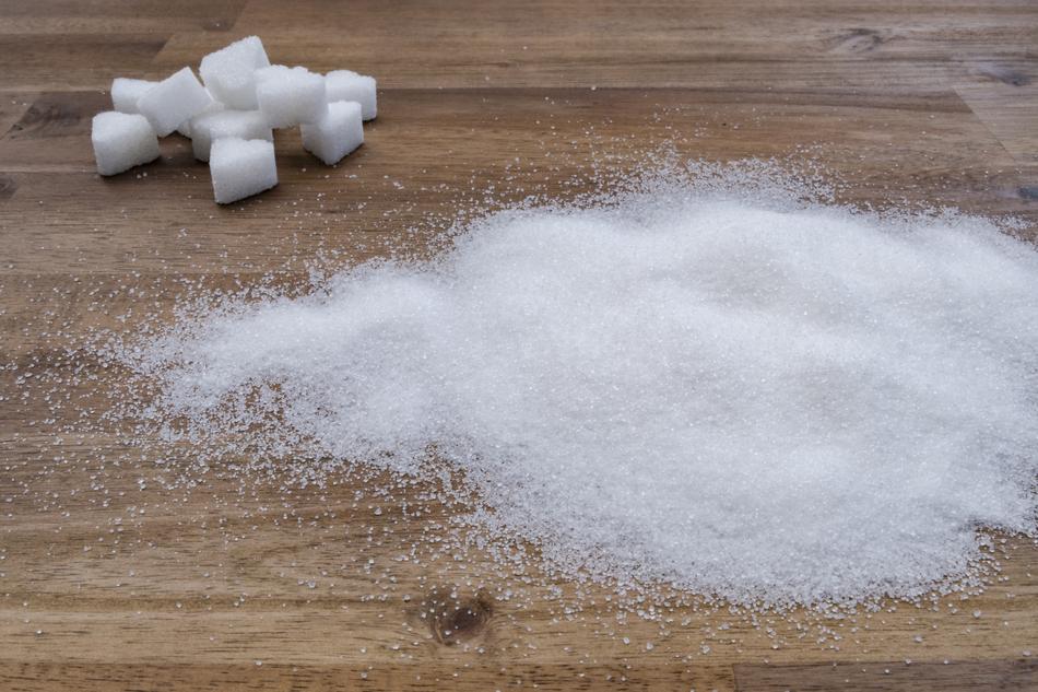 sugar in sand and cubes on a wooden cutting board
