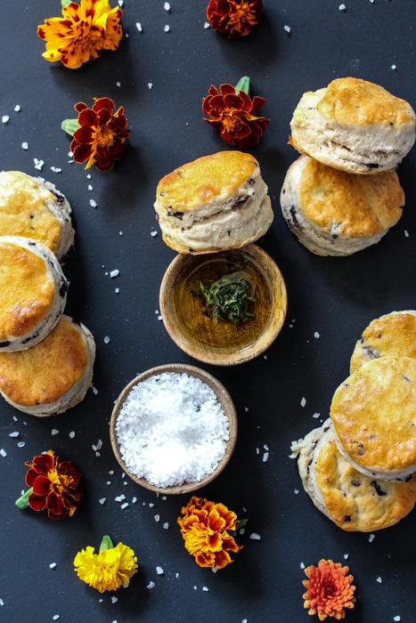Beautiful scones with herbs, salt and colorful flowers