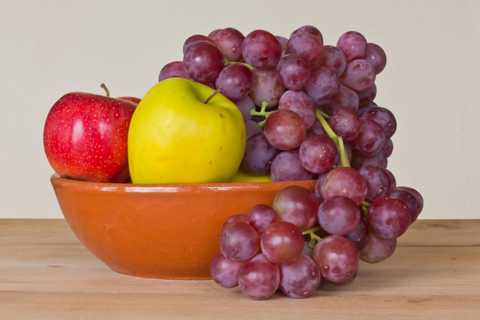 brown bowl with apples and grapes