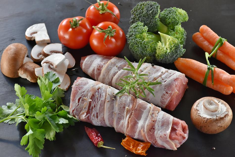 Port tenderloin and colorful vegetables, on the black surface