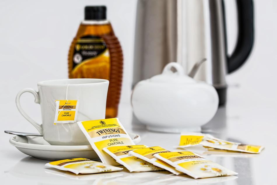 Cup of tee, teabags with camomile, and other tools for tea