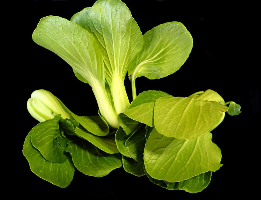 asian greens on black background