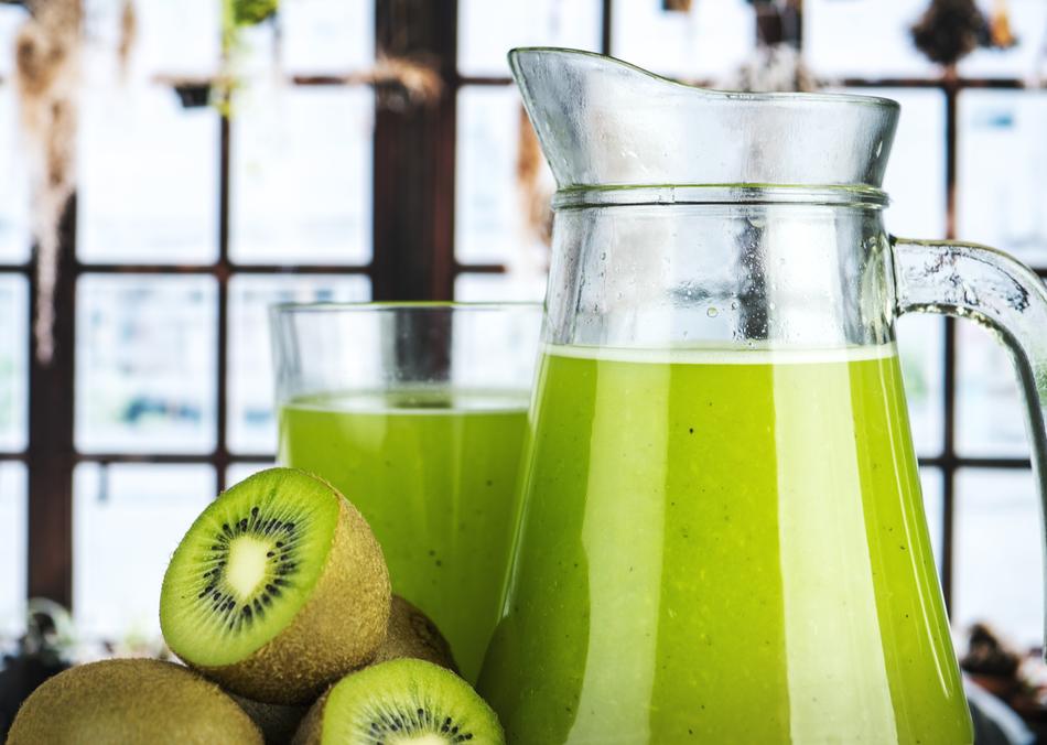 Beautiful, green frappe drink with kiwi, in the jug and glass