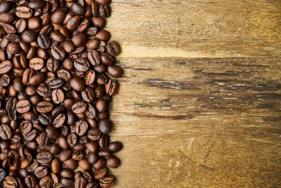 roasted coffee beans on a wooden table close up