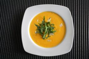 pumpkin soup with rucola as a dish