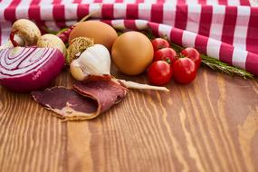 striped tablecloth, vegetables, eggs and jamon on the table