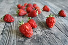 Beautiful, ripe, red strawberries on the wooden surface