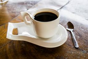 espresso cup on stand on a wooden table close up