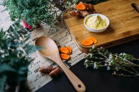wooden spoon and vegetables on table