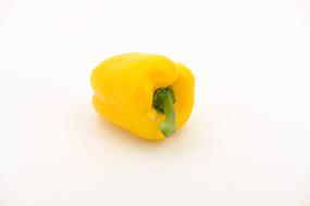 Beautiful, ripe, yellow paprika pepper, with shadow, on the white surface