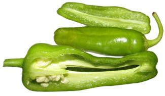 green chili peppers in a cut on white