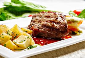 Beef Steak with garnish on a white plate