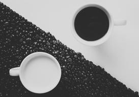 cup of milk and coffee on black and white table as a yin and yang symbol