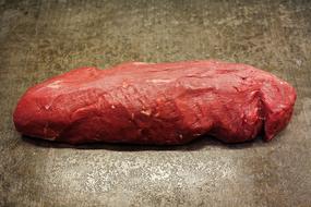 Close-up of the red, raw fillet of beef, in light