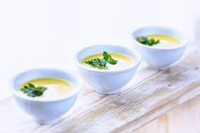 Leek and Potato soup with Parsley in white bowls
