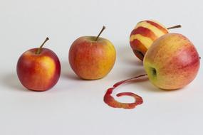 three apples and one peeled apple