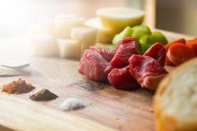 chopped meat on a cutting board while cooking