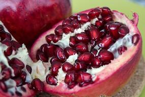 Macro photo of a beautiful, cut, sweet pomegranate with seeds