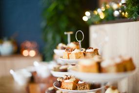 desserts and sandwiches on a table in a restaurant with a blurred background