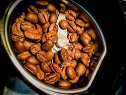 coffee beans in a manual coffee grinder
