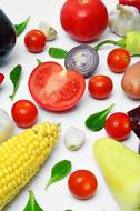 tomatoes, basil leaves, garlic and corn on the table