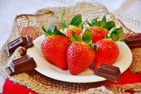 Strawberries and Chocolate on plate Close up