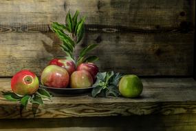 autumn still life, red apples on a wooden background