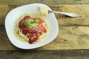 Pasta with tomato sauce and basil on plate