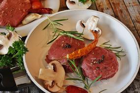 Close-up of the steak meat with steak meat, mushroom, pepper and rosemary