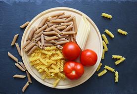 variety of pasta on a plate with tomato