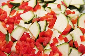 Cute green zucchinis and red paprika peppers