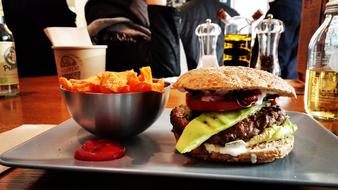 Beautiful and colorful hamburger, with the fries and sauce