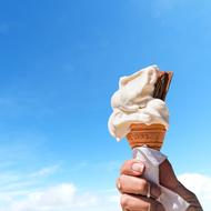 ice cream cone in hand in the sun