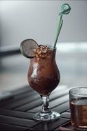 glass goblet with cappuccino on the table