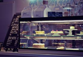 Colorful and beautiful cakes at the pastry counter in light
