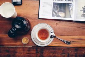 cup with a drink on a wooden table