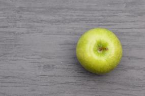 green apple on gray table